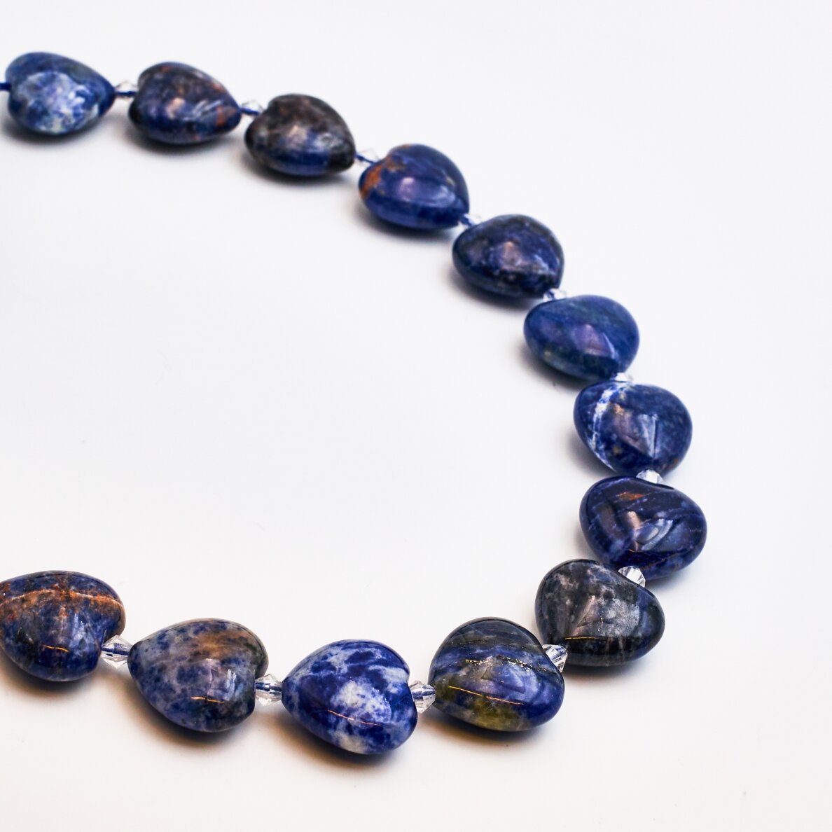 Sodalite, Natural, AB quality, curved heart shape, 39–40 cm/strand, 15 mm Sodalite, Natural, AB quality, curved heart shape, 39–40 cm/strand, 15 mm